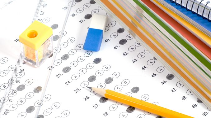 Test score with pencil, notebook and eraser